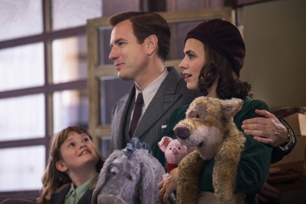 Madeline Robin (Bronte Carmichael), Christopher Robin (Ewan McGregor), Evelyn Robin (Hayley Atwell), Eeyore, Piglet and Tigger in Disney’s live-action adventure CHRISTOPHER ROBIN. | Credit: Walt Disney Studios